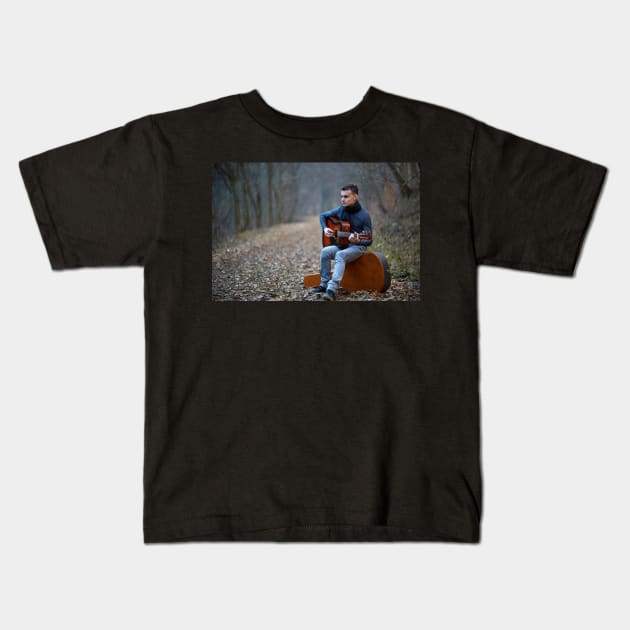 Guitarist singing outdoor in the forest Kids T-Shirt by naturalis